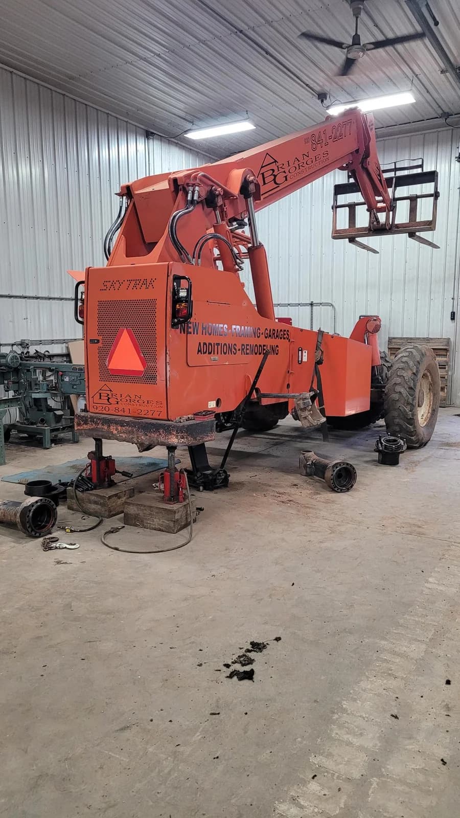 An orange machine inside the TerBeest workshop with components removed for repair